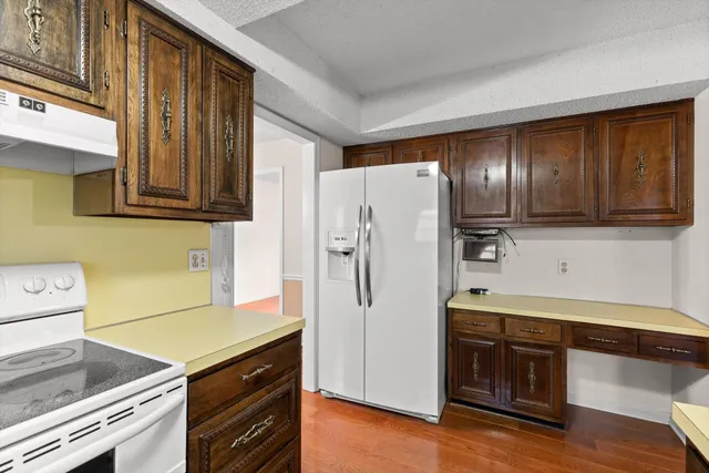 a kitchen with stainless steel appliances granite countertop a refrigerator stove and sink