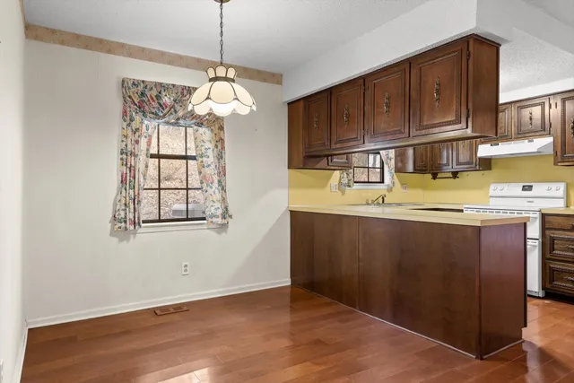 a kitchen with a sink cabinets and window