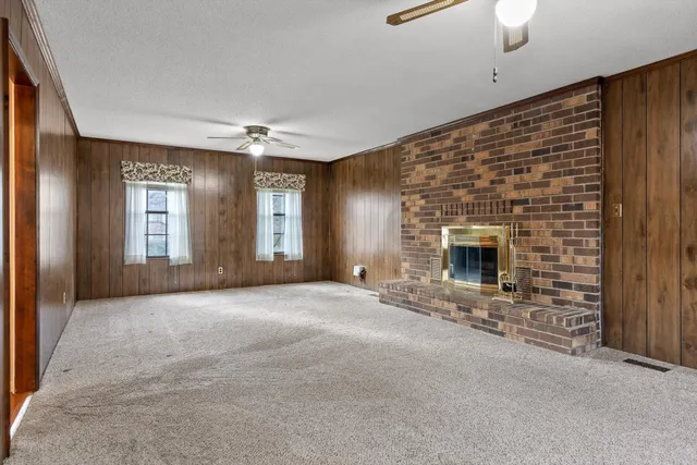a view of an empty room with a fireplace