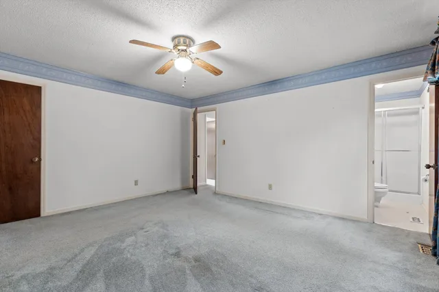 a view of an empty room with a fan