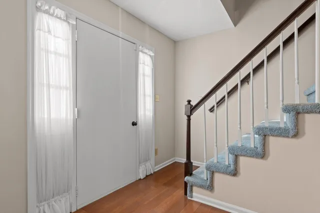 a view of entryway with wooden floor and stairs