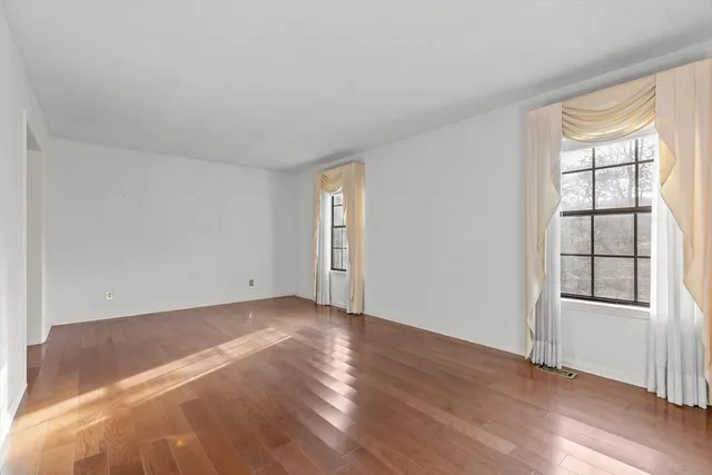 an empty room with windows and closet