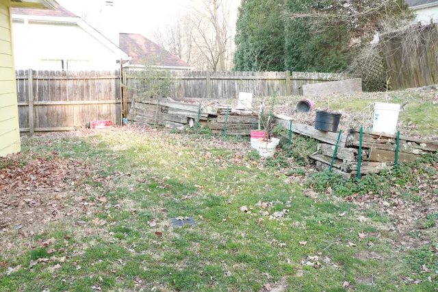 a backyard of a house with table and chairs