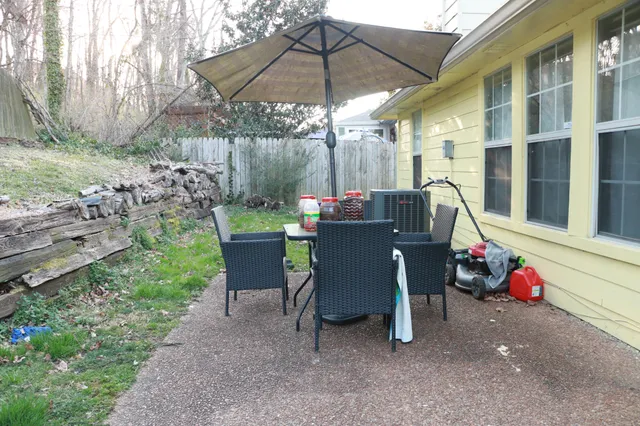 a view of a table and chairs in backyard