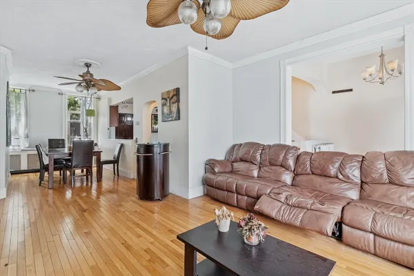 a living room with furniture wooden floor and dining table