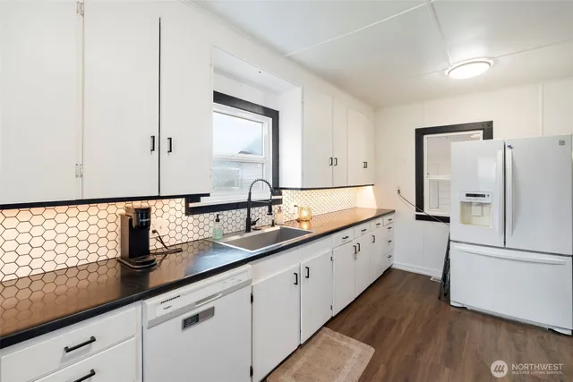 a kitchen with cabinets a sink and a window