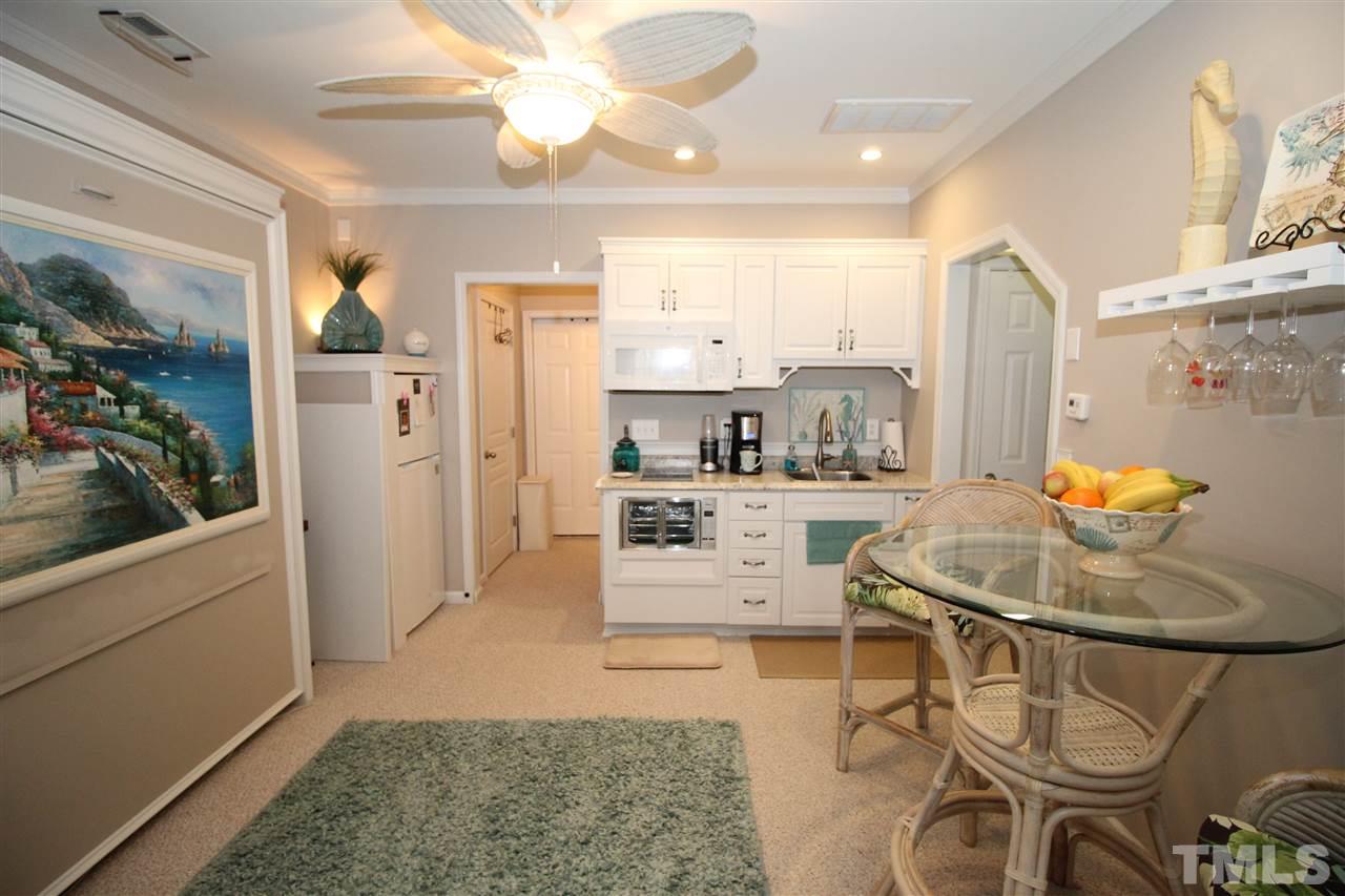 7757 Winners Edge Street Raleigh, NC 27617 - Photo 14 of 24 The area on the lower level has been turned into a "tiny house" style living! It is equipped with its own kitchenette, full bath, living room, bedroom/office space, even storage!