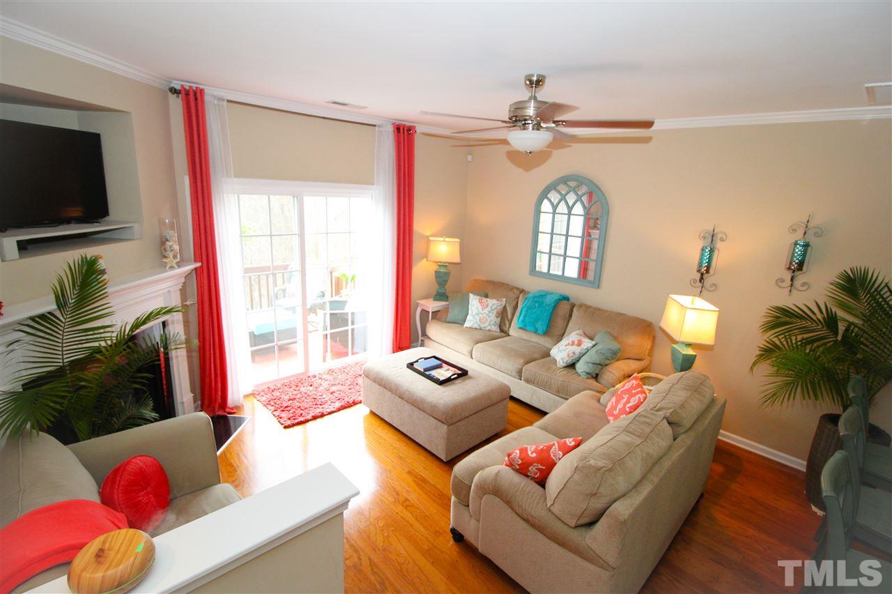 7757 Winners Edge Street Raleigh, NC 27617 - Photo 5 of 24 The Living Room is spacious and has a view to die for! Gas log fireplace for those cold nights and the deck looking out over the trees for the warm nights!