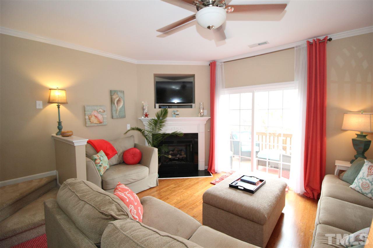 7757 Winners Edge Street Raleigh, NC 27617 - Photo 6 of 24 The Living Room has hardwood floors, ceiling fan and lots of natural light shining in!
