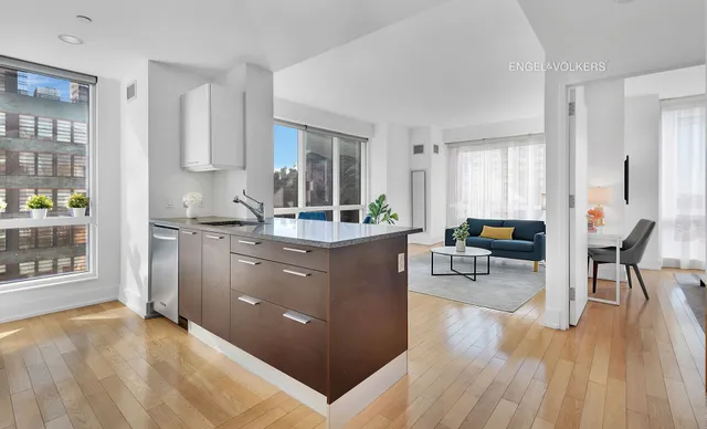 a kitchen with sink cabinets and wooden floor