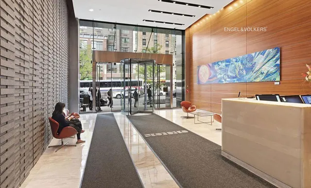 a dining room with a large window and couch