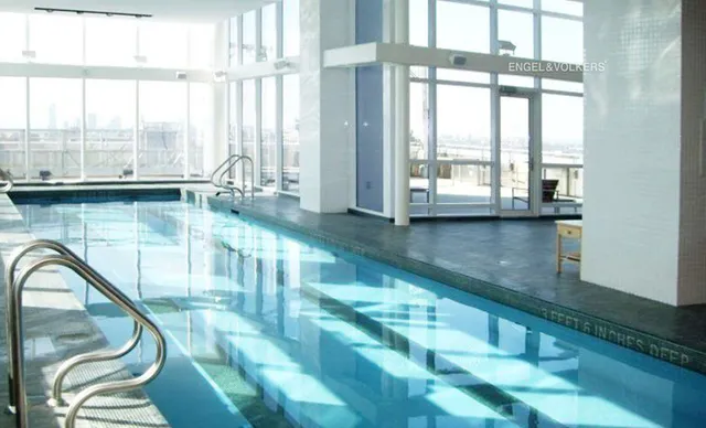 a kitchen with stainless steel appliances granite countertop sink table and chairs