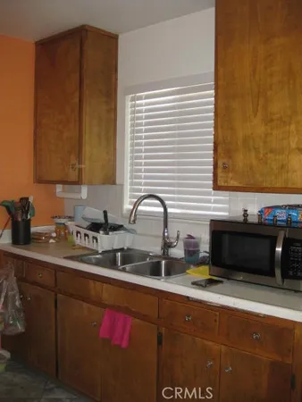 a kitchen with sink cabinets and window