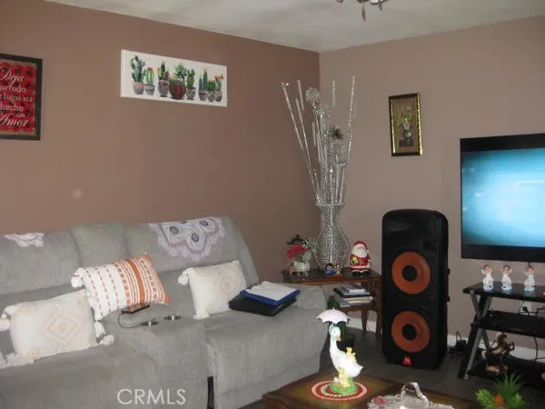 a living room with furniture and wall painting