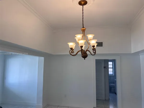 a view of a chandelier fan and a wooden floor in a room