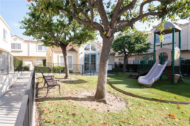 a view of house with a yard and sitting area