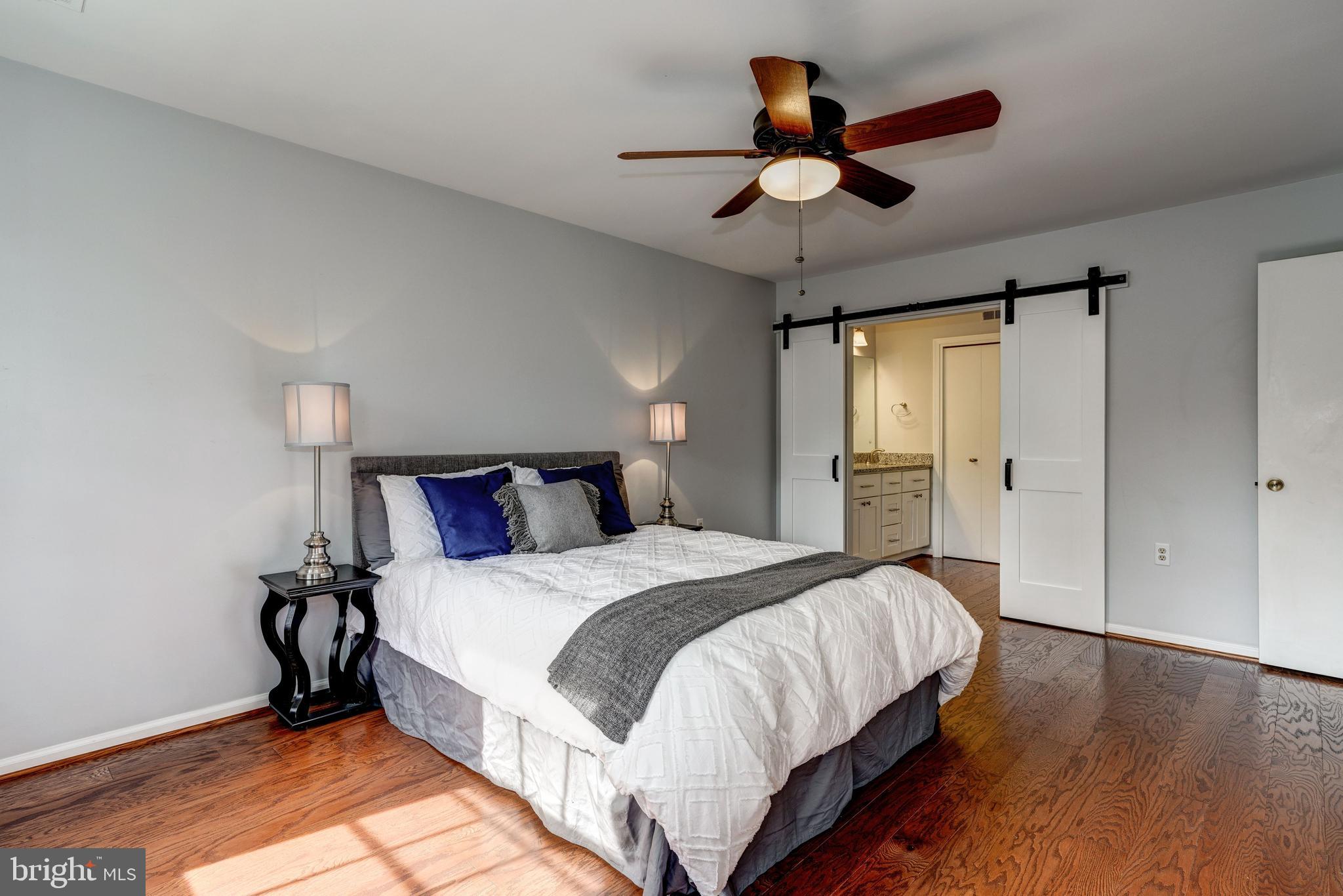 8218 Riverside Road Alexandria, VA 22308 - Photo 11 of 21 Master bedroom w/ barn doors