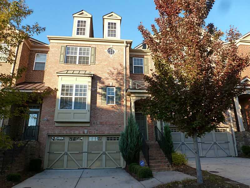 Exterior Front. brickfront townhome with two car garage