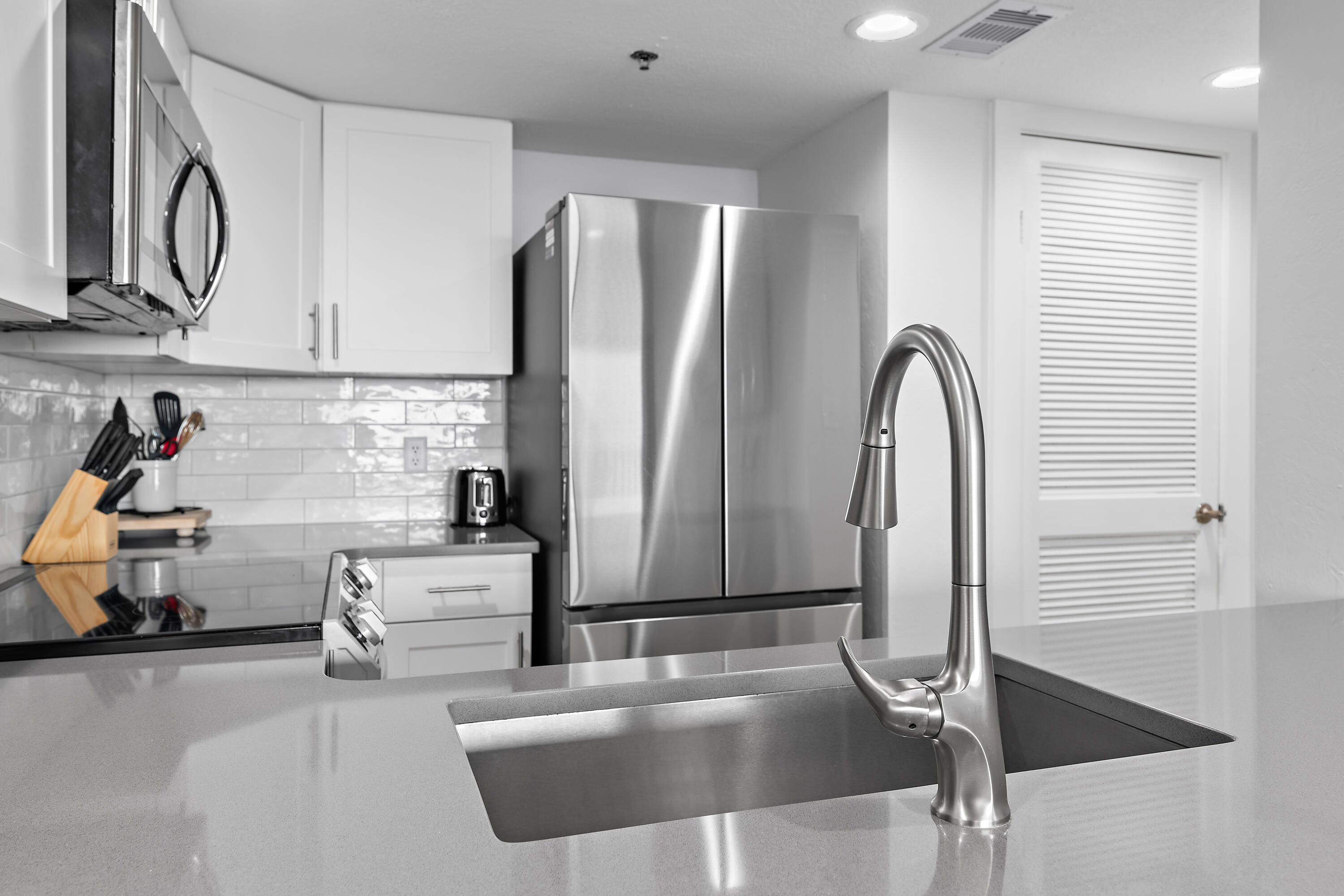 4100 East County Highway 30A, Unit 1805 Santa Rosa Beach, FL 32459 - Photo 13 of 35 a kitchen with stainless steel appliances granite countertop a refrigerator and a sink