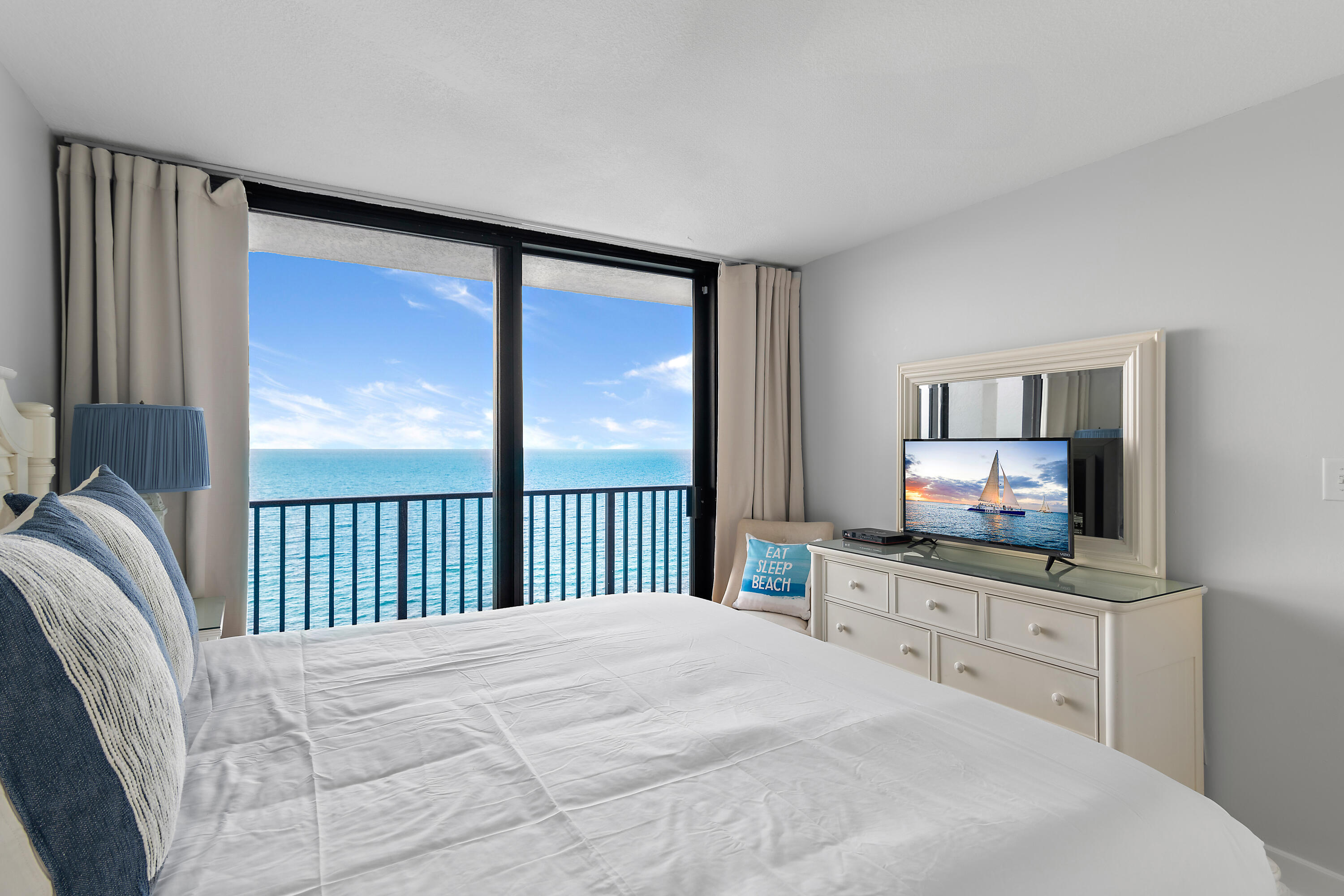 4100 East County Highway 30A, Unit 1805 Santa Rosa Beach, FL 32459 - Photo 17 of 35 a bedroom with a large bed and a flat tv screen on dresser