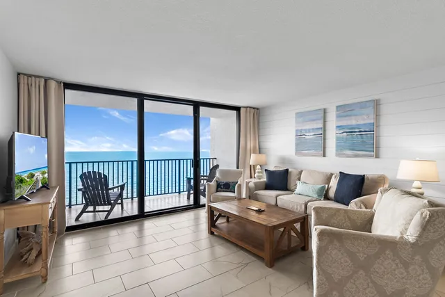 a living room with furniture and large windows