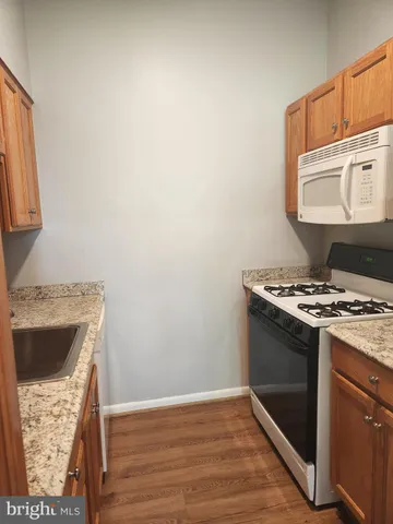 a view of kitchen island with wooden floor