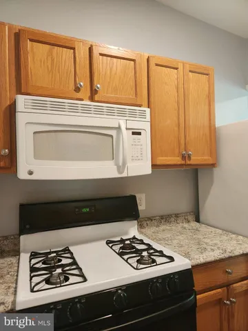 a kitchen with a stove and a cabinets