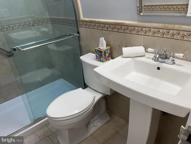 a white toilet sitting next to a bathroom sink