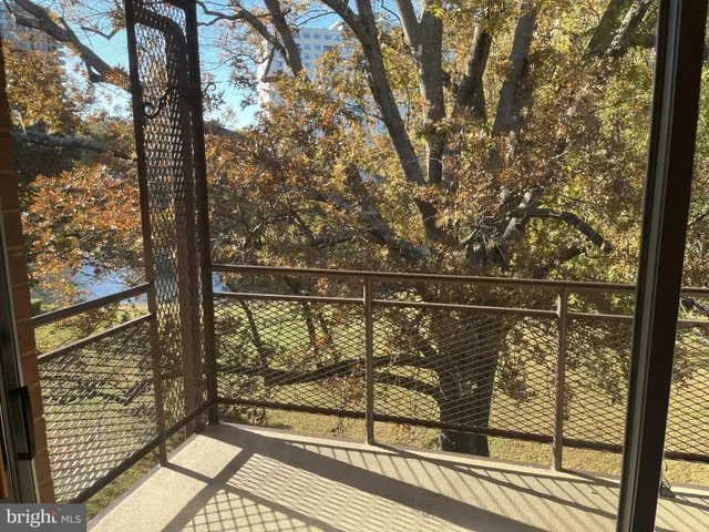 a view of a balcony with wooden floor and fence