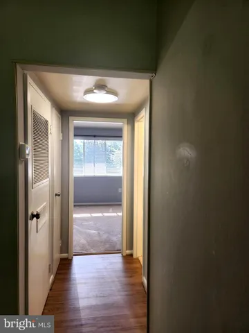 wooden floor in an empty room with a mirror