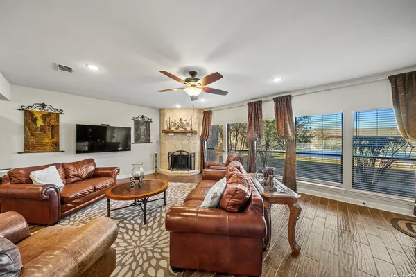 a living room with furniture floor and a flat screen tv