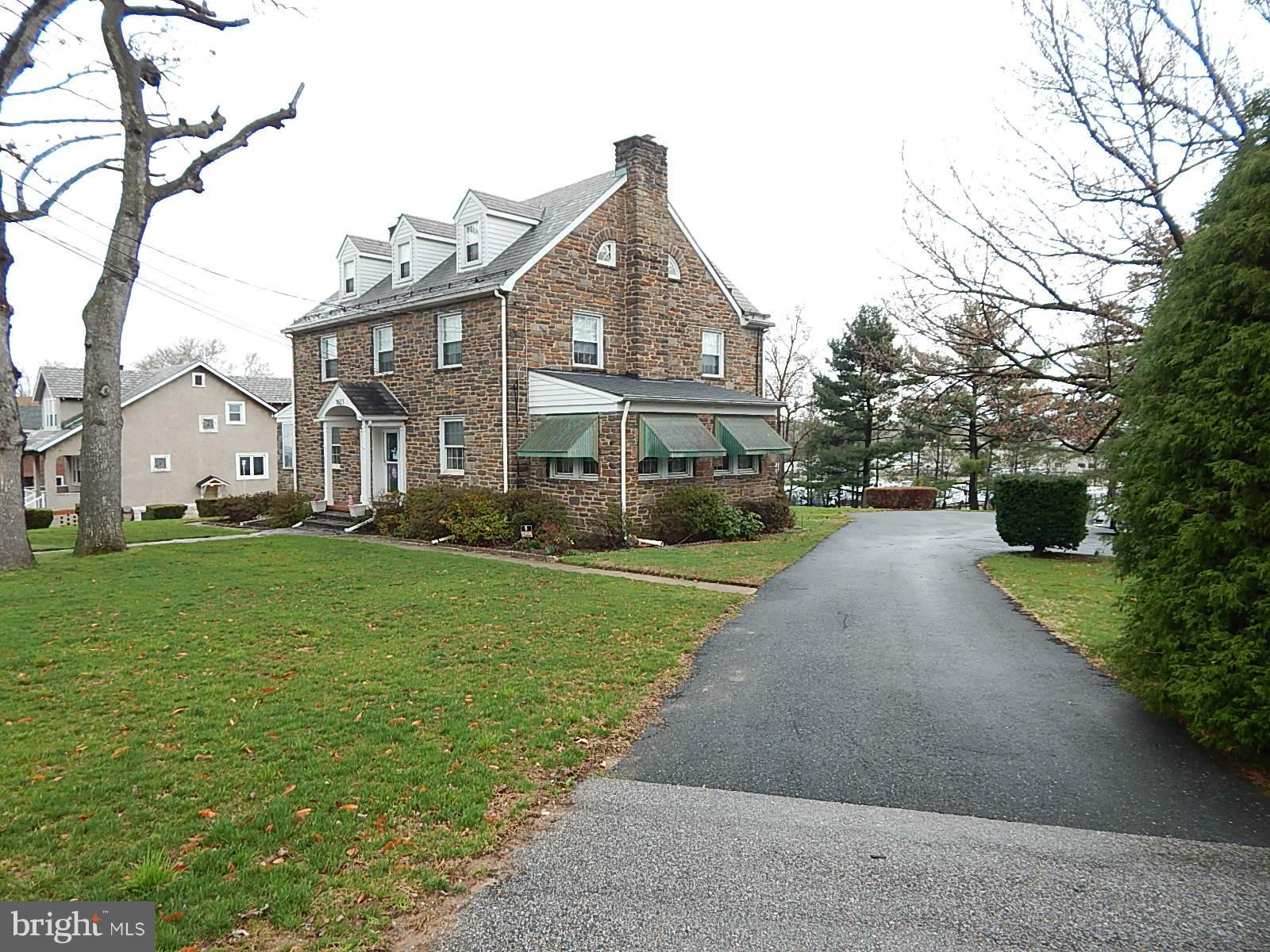 7623 Philadelphia Road Baltimore, MD 21237 - Photo 2 of 28 a front view of a house with a yard