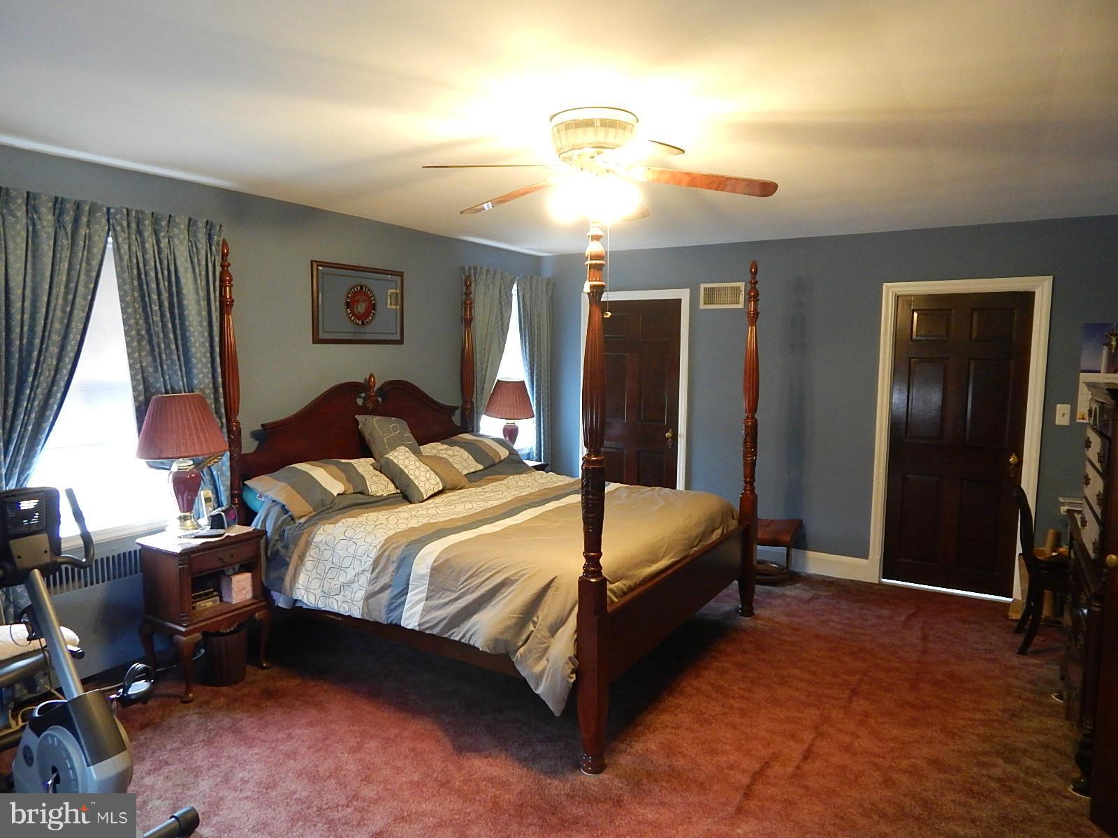 7623 Philadelphia Road Baltimore, MD 21237 - Photo 11 of 28 a spacious bedroom with a bed and a chandelier
