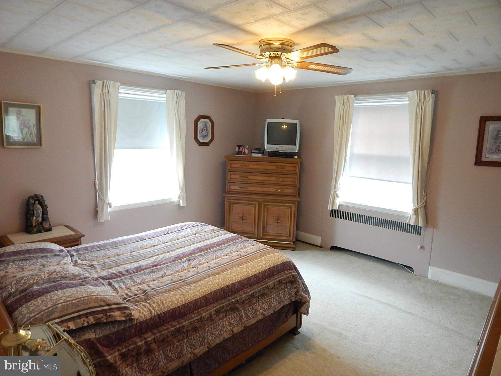 7623 Philadelphia Road Baltimore, MD 21237 - Photo 13 of 28 a bedroom with a bed and a chandelier