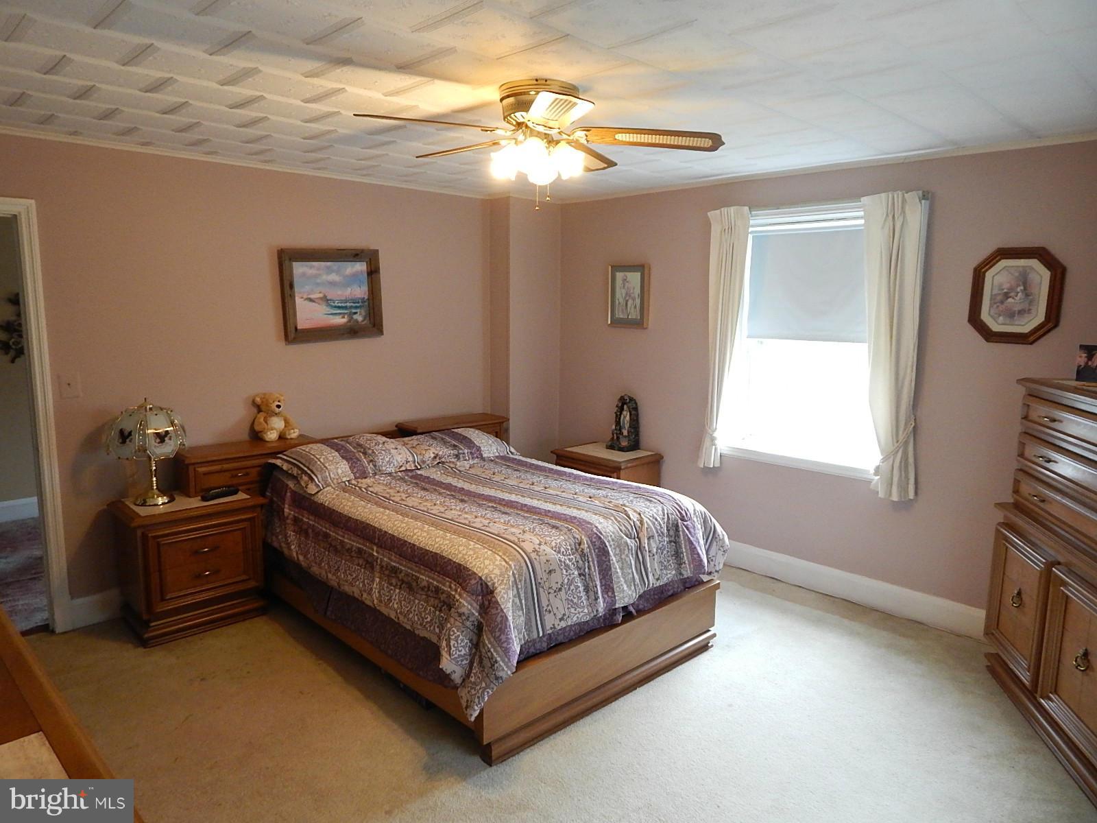 7623 Philadelphia Road Baltimore, MD 21237 - Photo 14 of 28 a spacious bedroom with a bed and a window