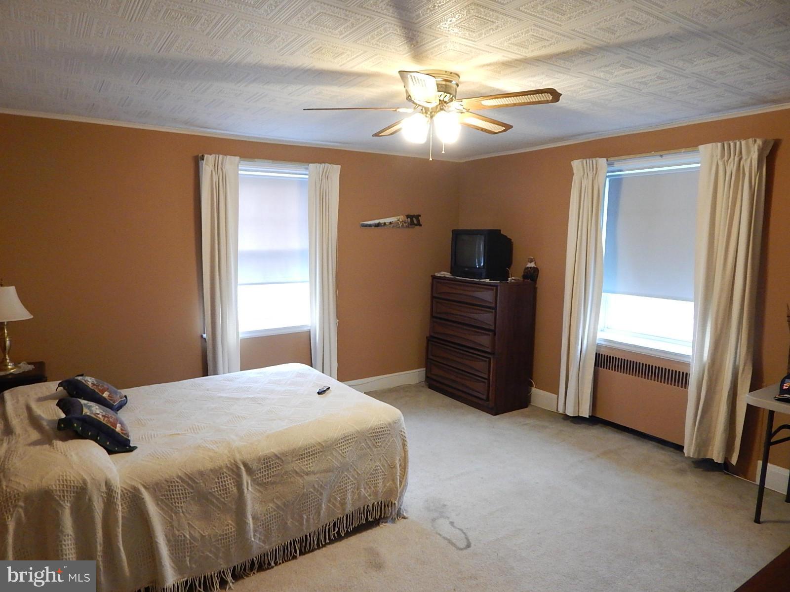 7623 Philadelphia Road Baltimore, MD 21237 - Photo 15 of 28 a bedroom with a bed and a chandelier