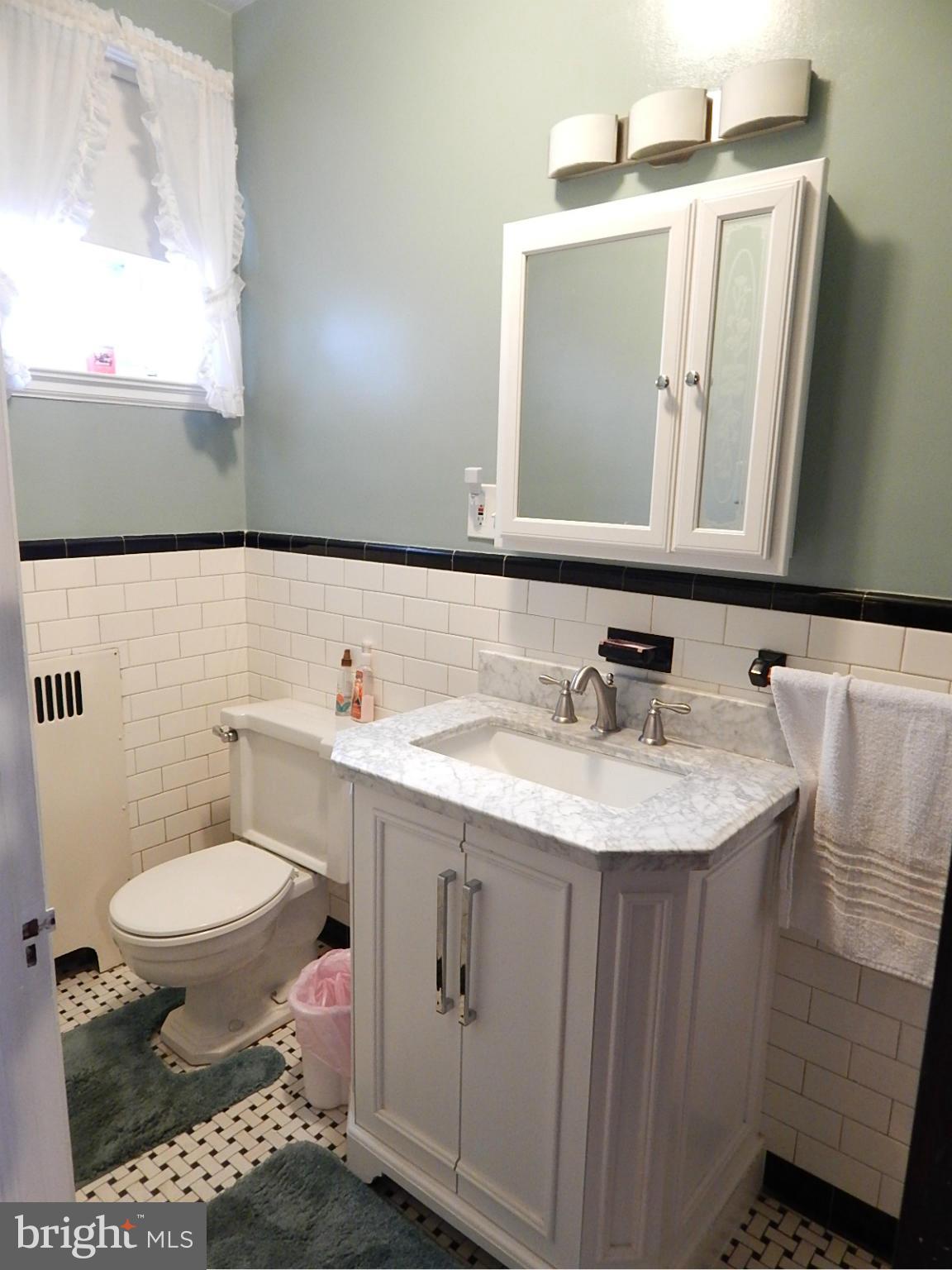 7623 Philadelphia Road Baltimore, MD 21237 - Photo 18 of 28 a bathroom with a sink toilet and mirror