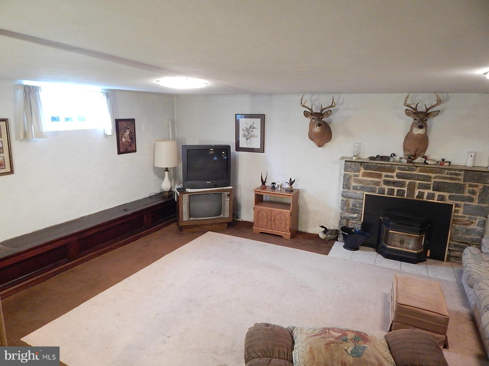 7623 Philadelphia Road Baltimore, MD 21237 - Photo 20 of 28 a living room with furniture and a fireplace