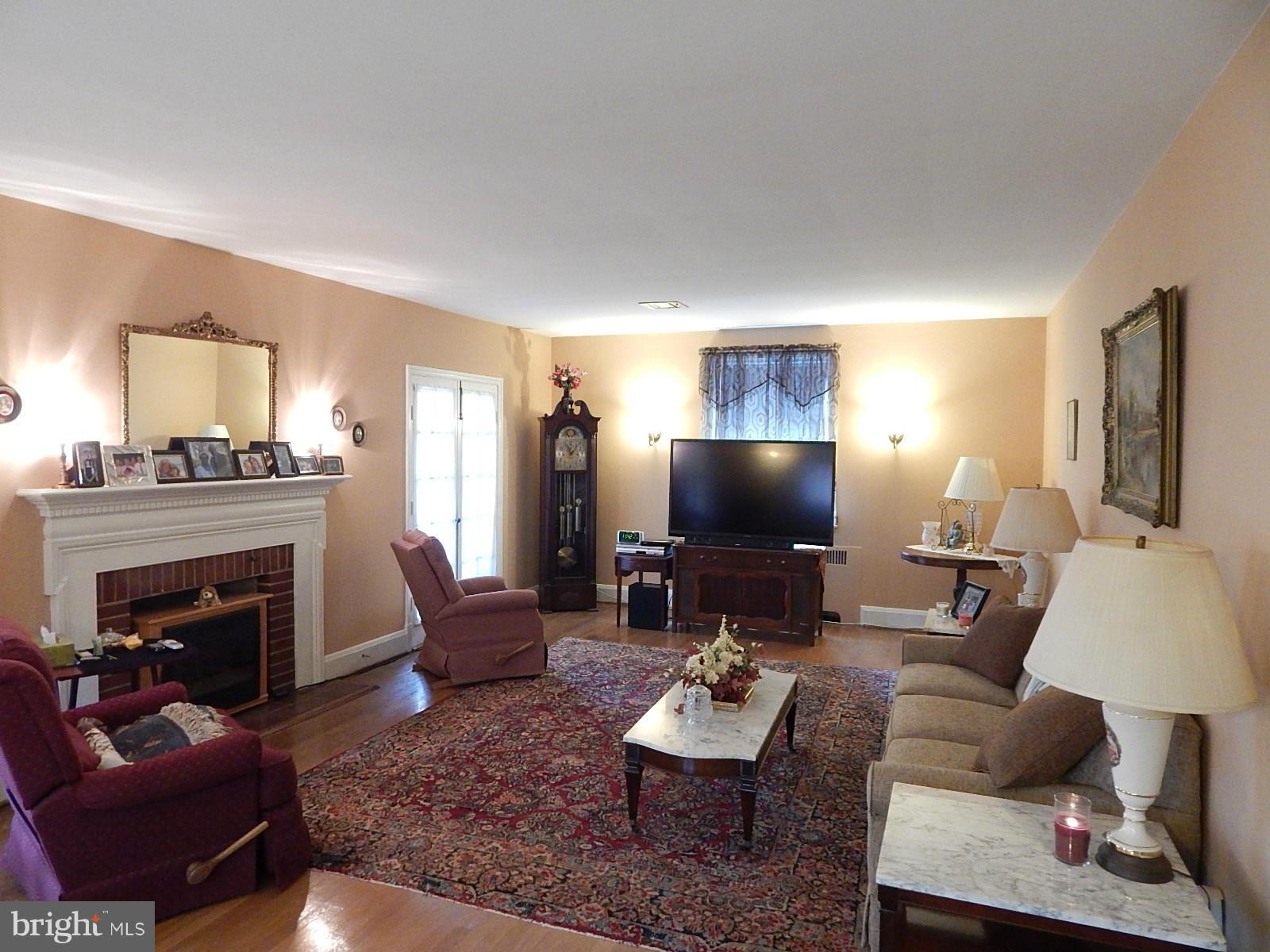 7623 Philadelphia Road Baltimore, MD 21237 - Photo 4 of 28 a living room with furniture and a fireplace