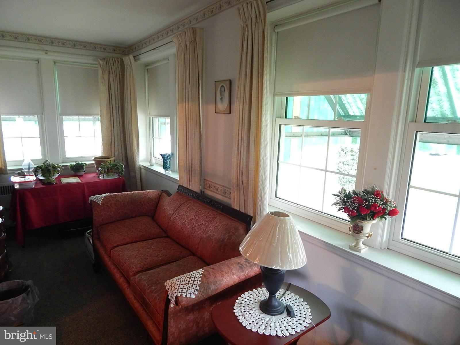7623 Philadelphia Road Baltimore, MD 21237 - Photo 7 of 28 a living room with furniture and a large window
