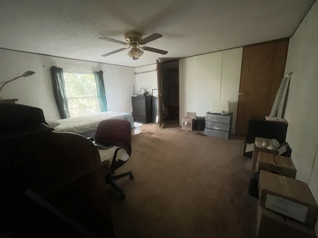a view of a livingroom with furniture and a window