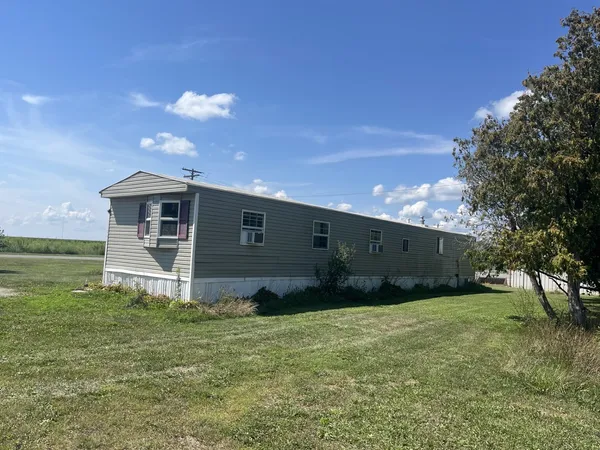 a front view of house with yard and garage