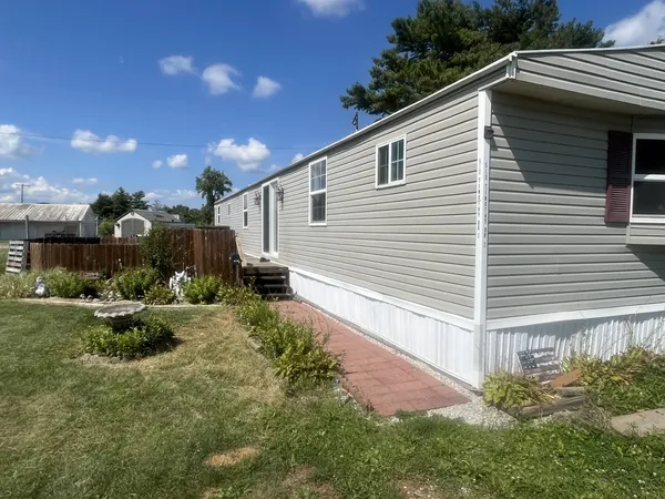 a view of backyard with plants and outdoor seating