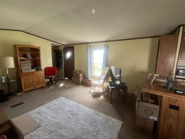 a living room with furniture gym equipment and a flat screen tv