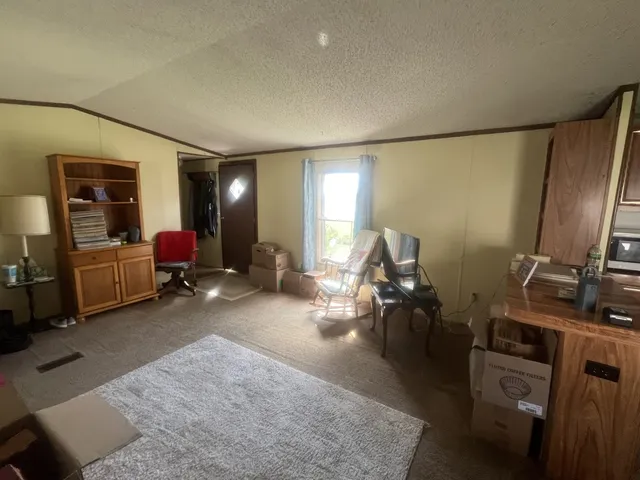 a living room with furniture gym equipment and a flat screen tv