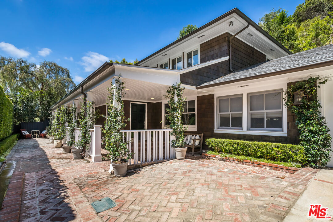 919 Chantilly Road Los Angeles, CA 90077 - Photo 1 of 23 a view of a house with a yard