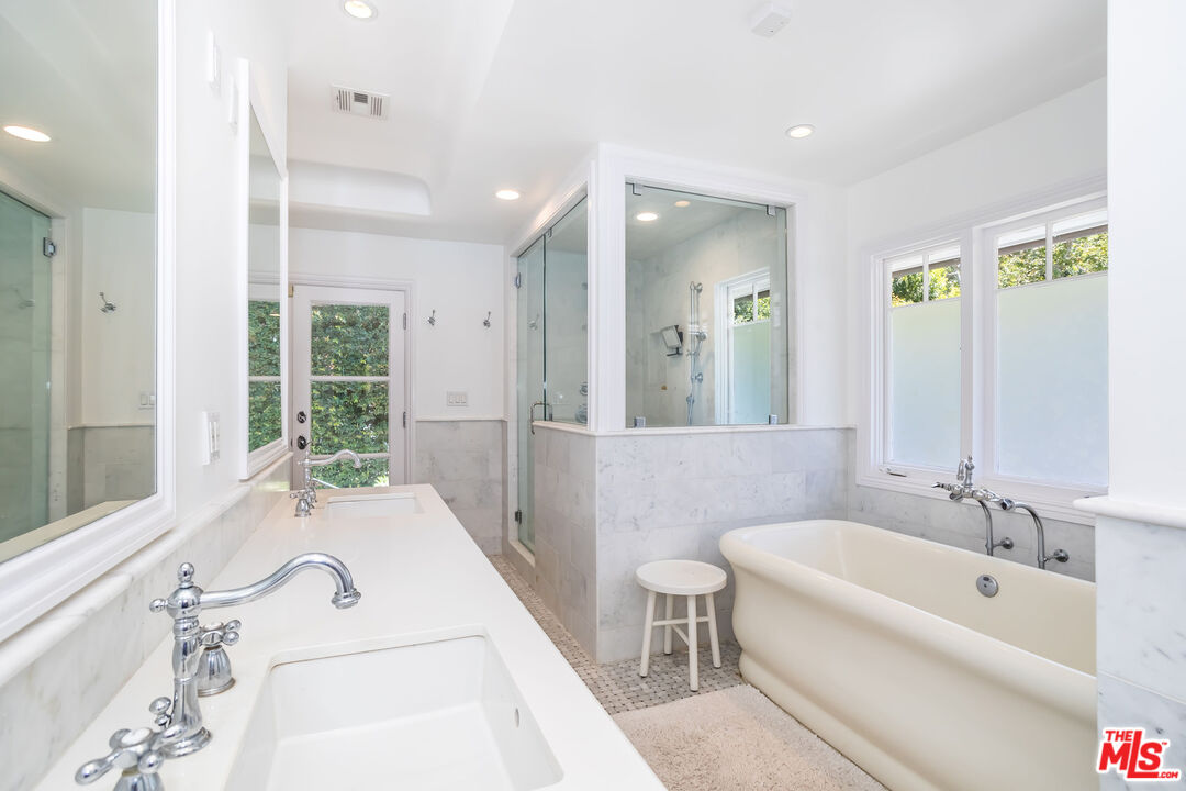919 Chantilly Road Los Angeles, CA 90077 - Photo 13 of 23 a bathroom with a tub sink and mirror