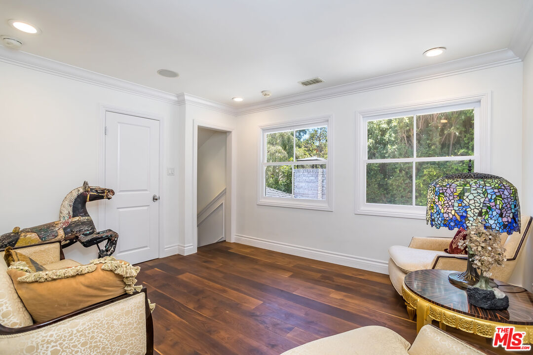 919 Chantilly Road Los Angeles, CA 90077 - Photo 17 of 23 a bedroom with furniture and a window