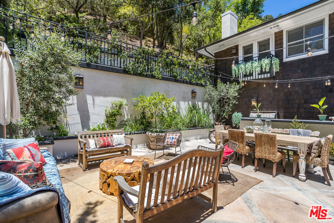 919 Chantilly Road Los Angeles, CA 90077 - Photo 20 of 23 a view of a patio with couches table and chairs and potted plants