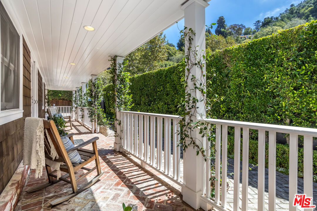 919 Chantilly Road Los Angeles, CA 90077 - Photo 3 of 23 a view of balcony with wooden floor and outdoor seating